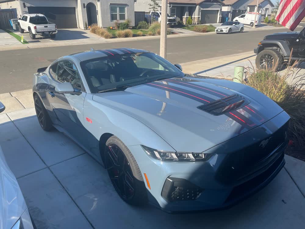 Silver Ford Mustang with red vinyl stripes
