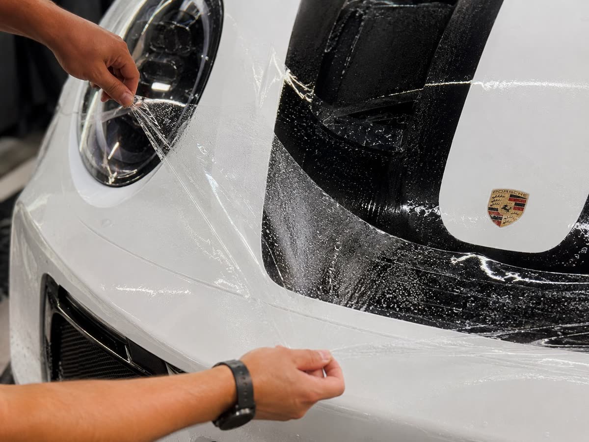 Paint protection film applied to a white Porsche front end