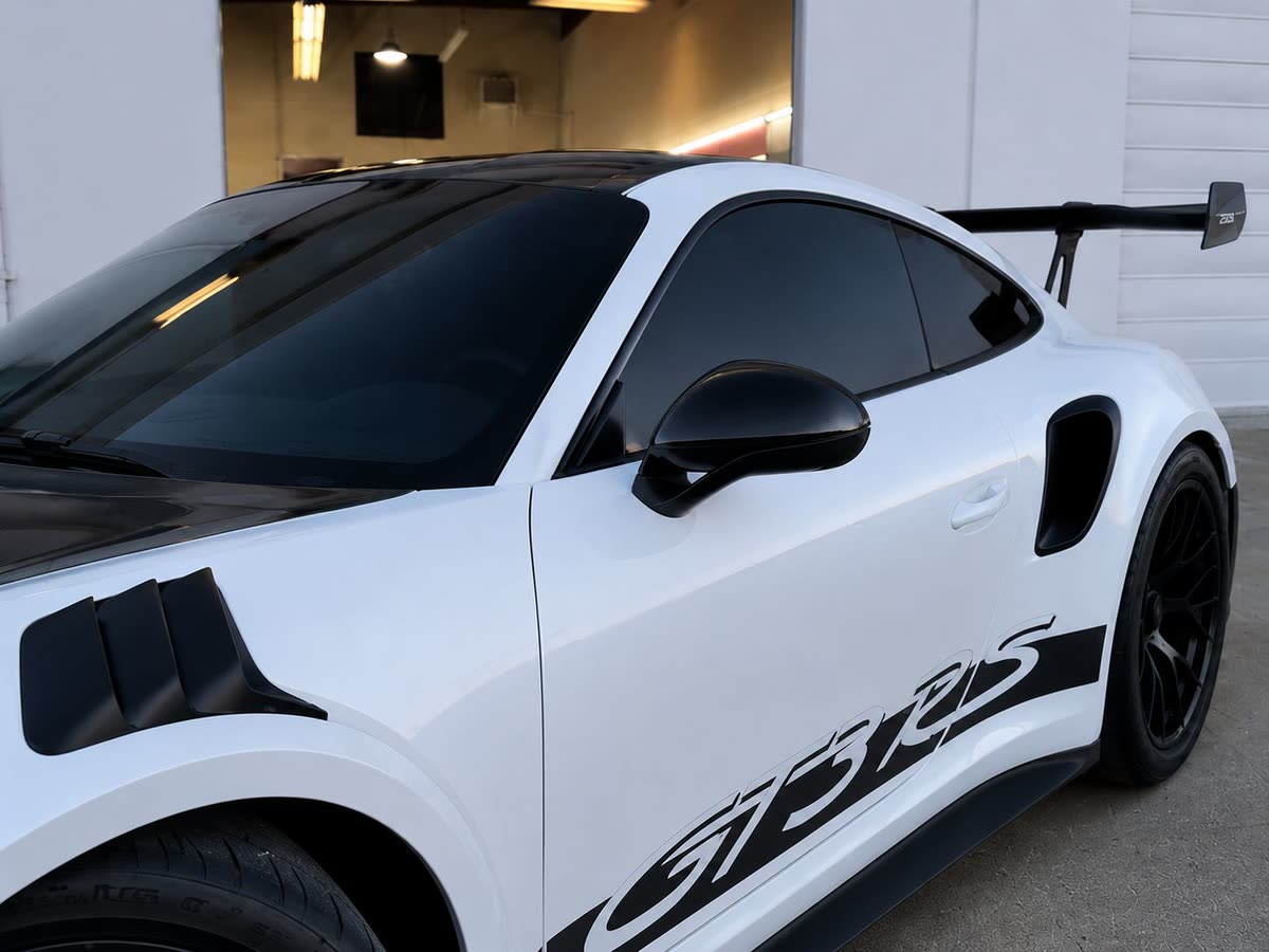 White Porsche 911 GT3 RS with blacked-out window tint